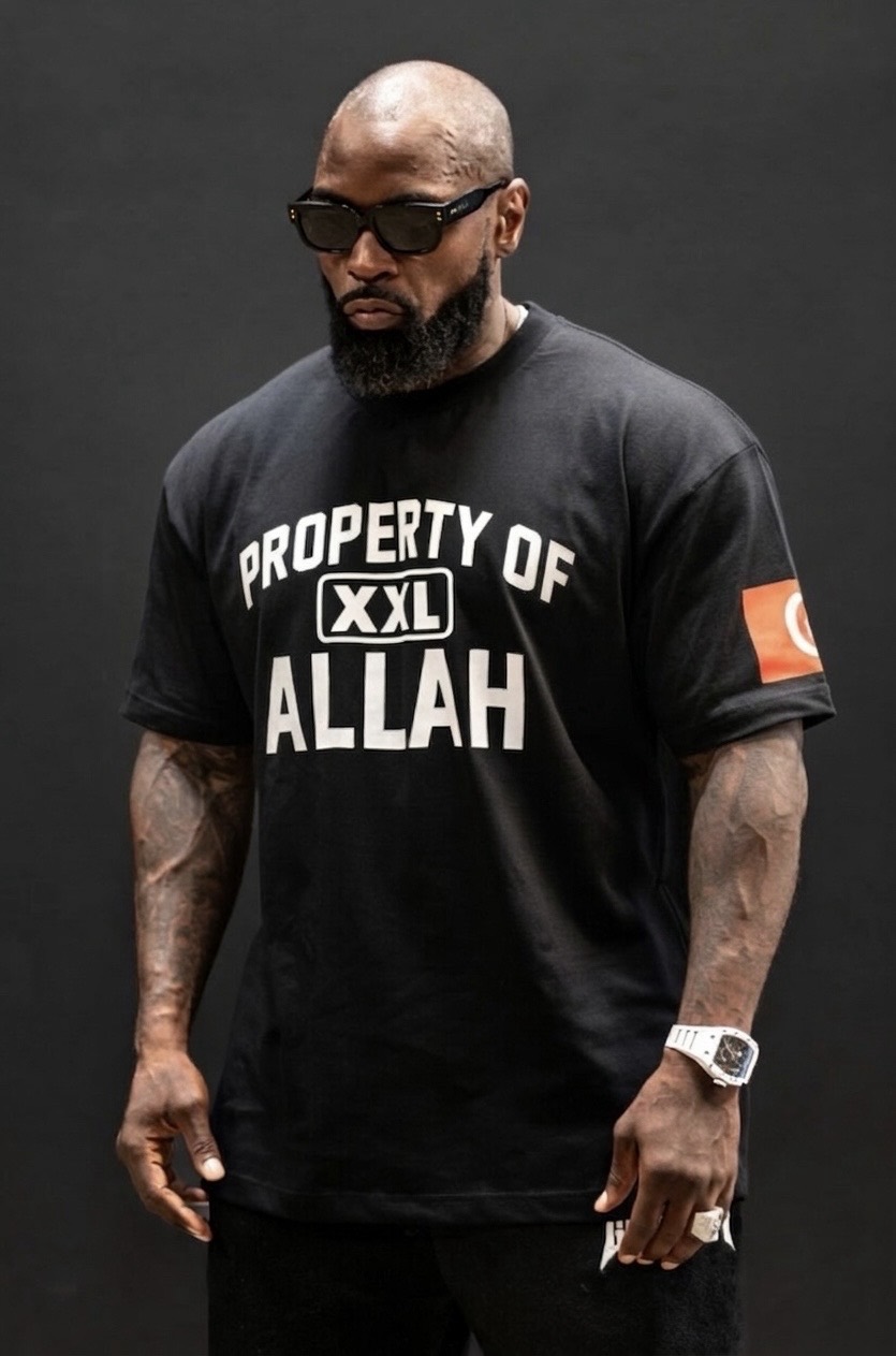 Mike Rashid wearing sunglasses and a black Property of Allah shirt